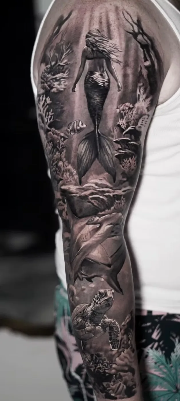 Full black and grey sleeve of a mermaid and ocean scene
